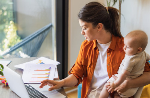 Woman multitasking holding baby